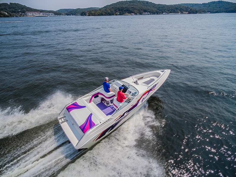 A speedboat racing down the lake