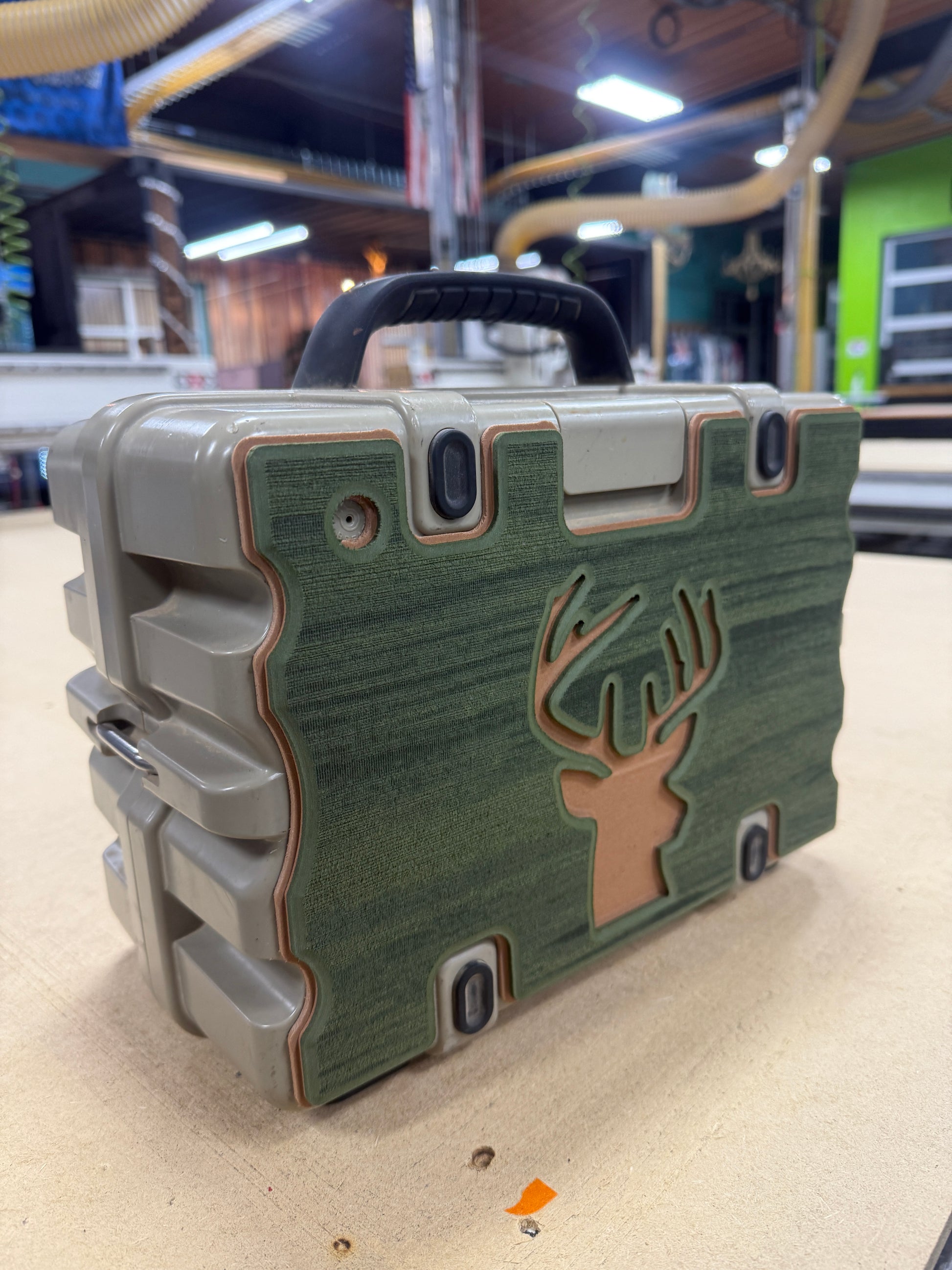 Green rugged case with a logo on a reflective surface