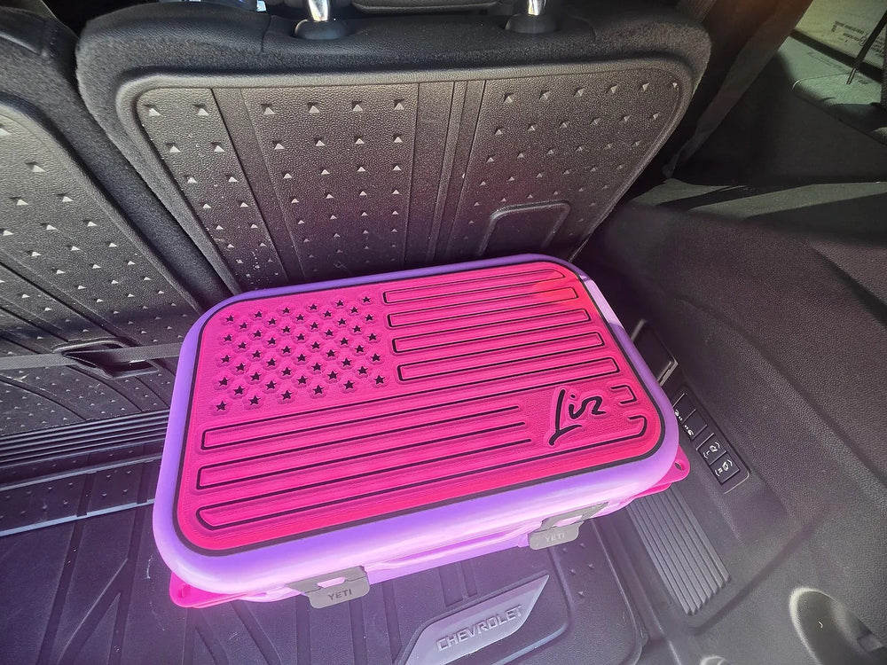 Pink American flag cooler top pad with the name Liz on a Yeti cooler